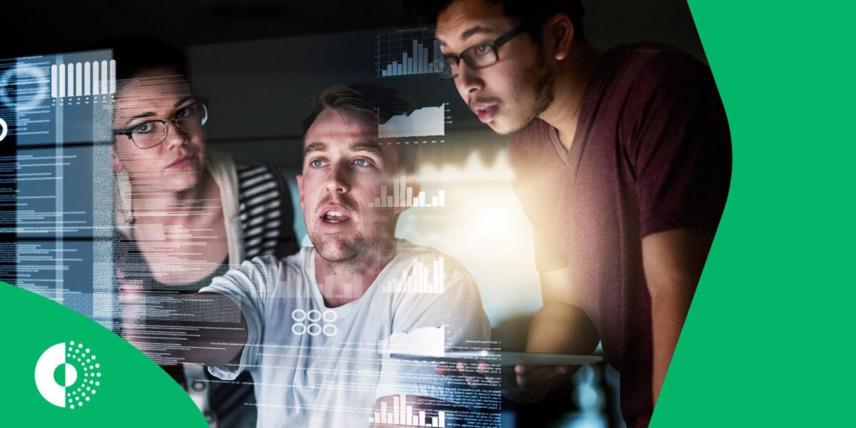 Group of people working in the tourism/travel industry collaborating around a large screen displaying complex data visualizations, representing the application of big data and real-time intelligence.