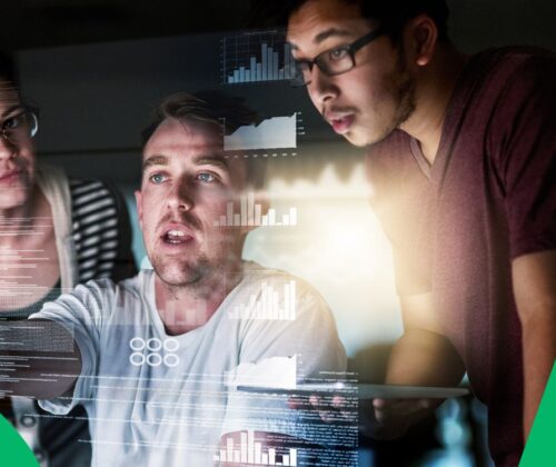 Group of people working in the tourism/travel industry collaborating around a large screen displaying complex data visualizations, representing the application of big data and real-time intelligence.