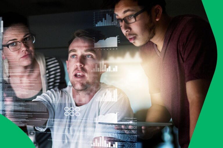 Group of people working in the tourism/travel industry collaborating around a large screen displaying complex data visualizations, representing the application of big data and real-time intelligence.